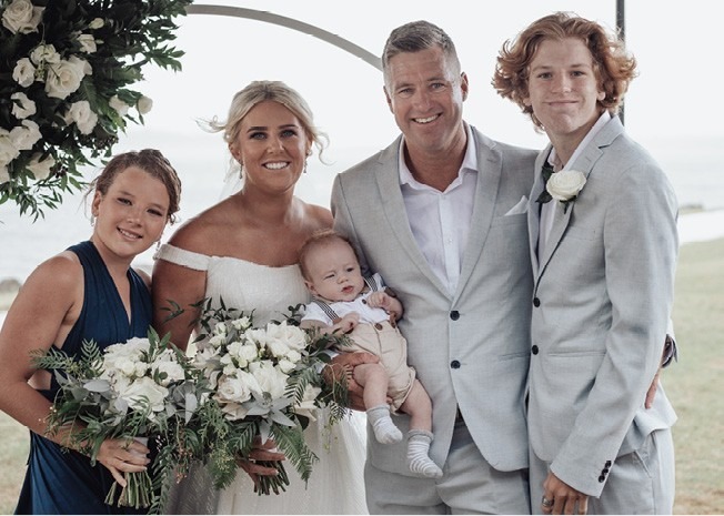 Daniel and Kim with their family on their wedding day